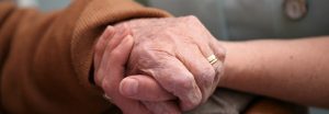 Elderly hand holding another hand